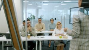 Coworkers reviewing a task list together at a workplace table